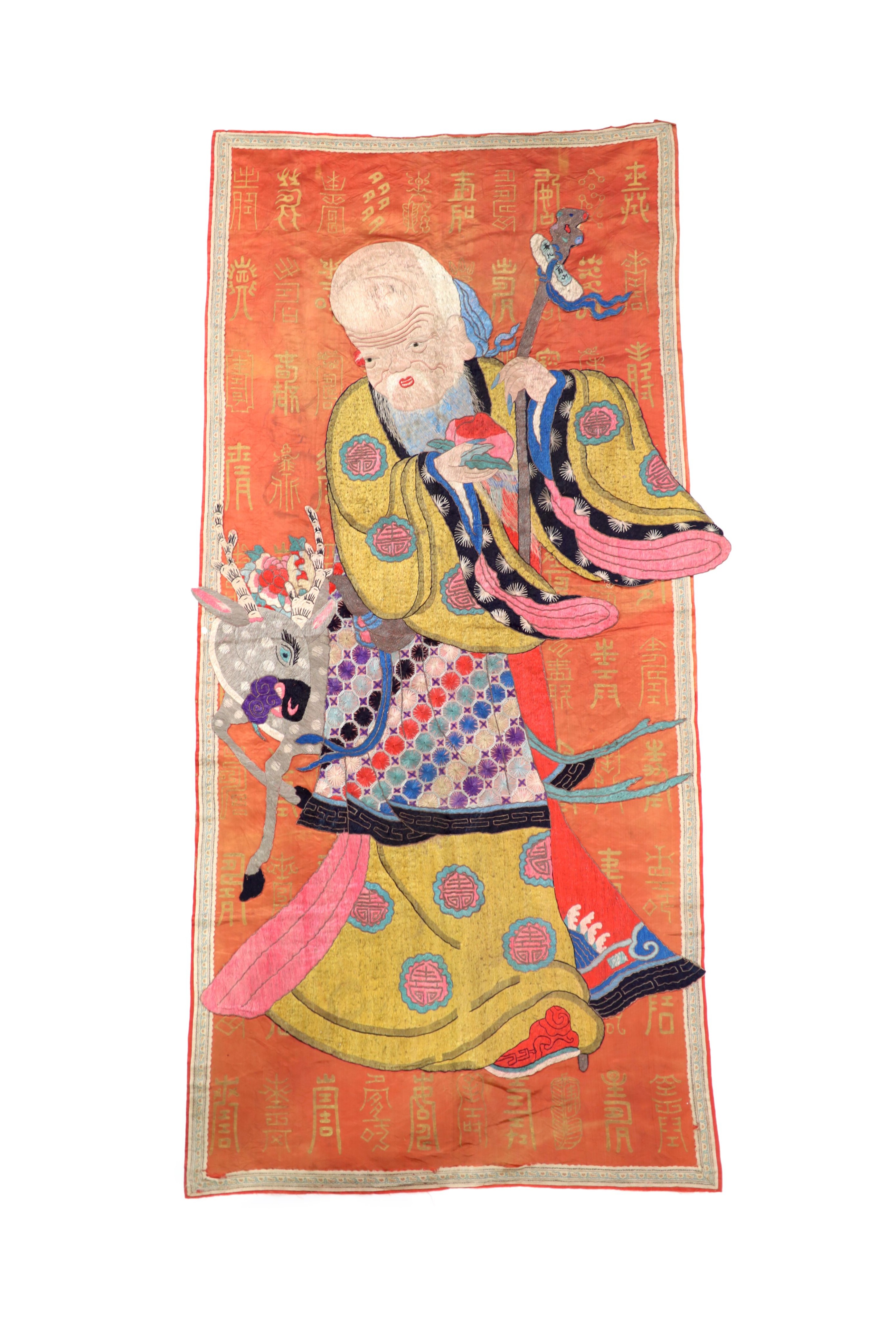 A Chinese embroidered silk ‘Shou Lao’ panel, late 19th century, 168 cm x 77 cm